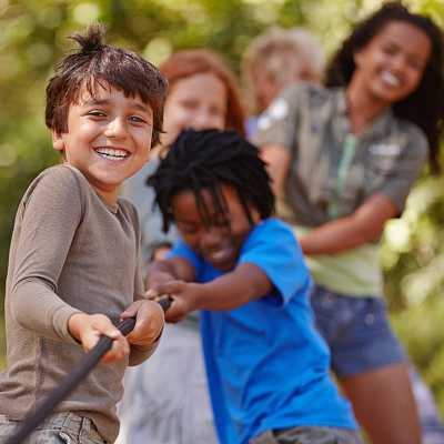 A group of children playing tug-of-war