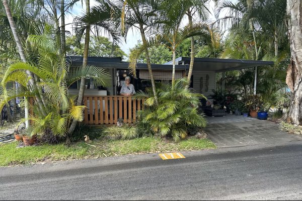 A woman stands on the deck of her home at Kirra Beach Tourist Park, photo: Danielle Mahe